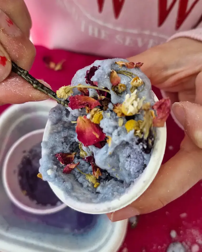 Child stirring a shimmering Faerie Secrets potion filled with blue fizz, petals, and sparkles — handmade magical potion for kids by Sparkle & Spell Co.