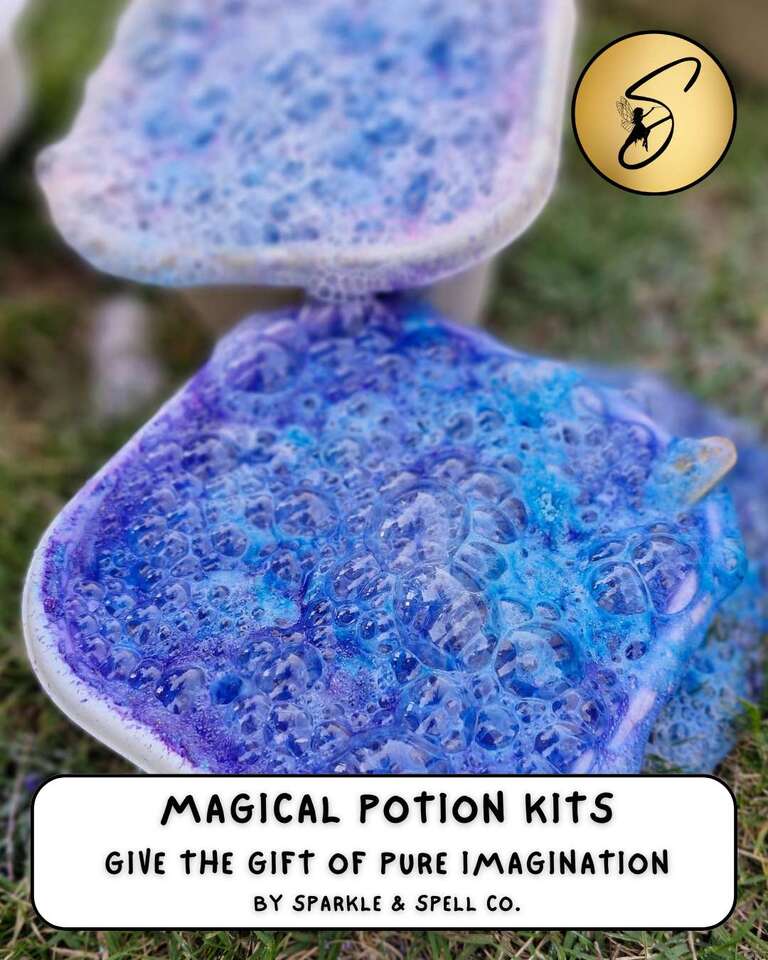 Fizzing, bubbling blue and purple magic potion play setup on grass, part of Sparkle & Spell Co.'s Magical Potion Kits collection for creative play.